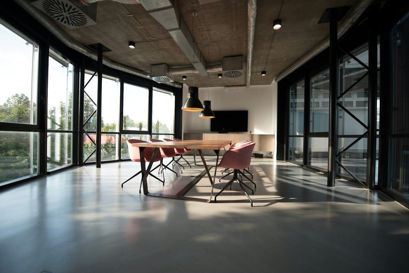 Light-filled office meeting room with a long table and chairs